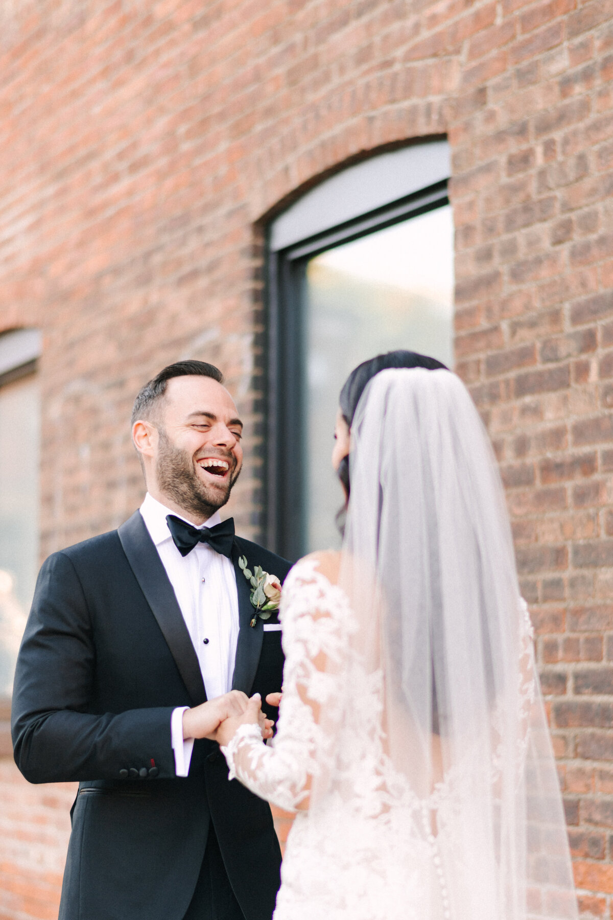groom smiles after seeing his bride during first look