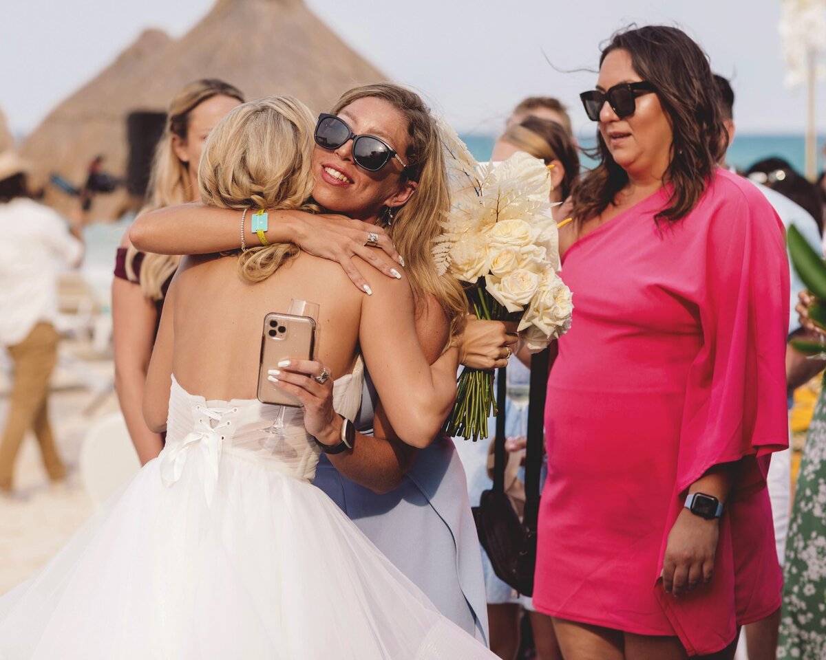 Bride hugging guests at wedding in Riviera Maya