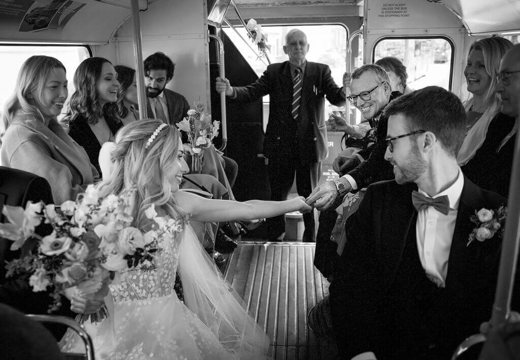Bride on wedding buss fist bumps father of bride