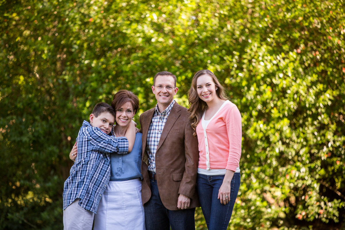 portrait photography outdoors of family smiling on porch by San Antonio Photographer Expose The Heart