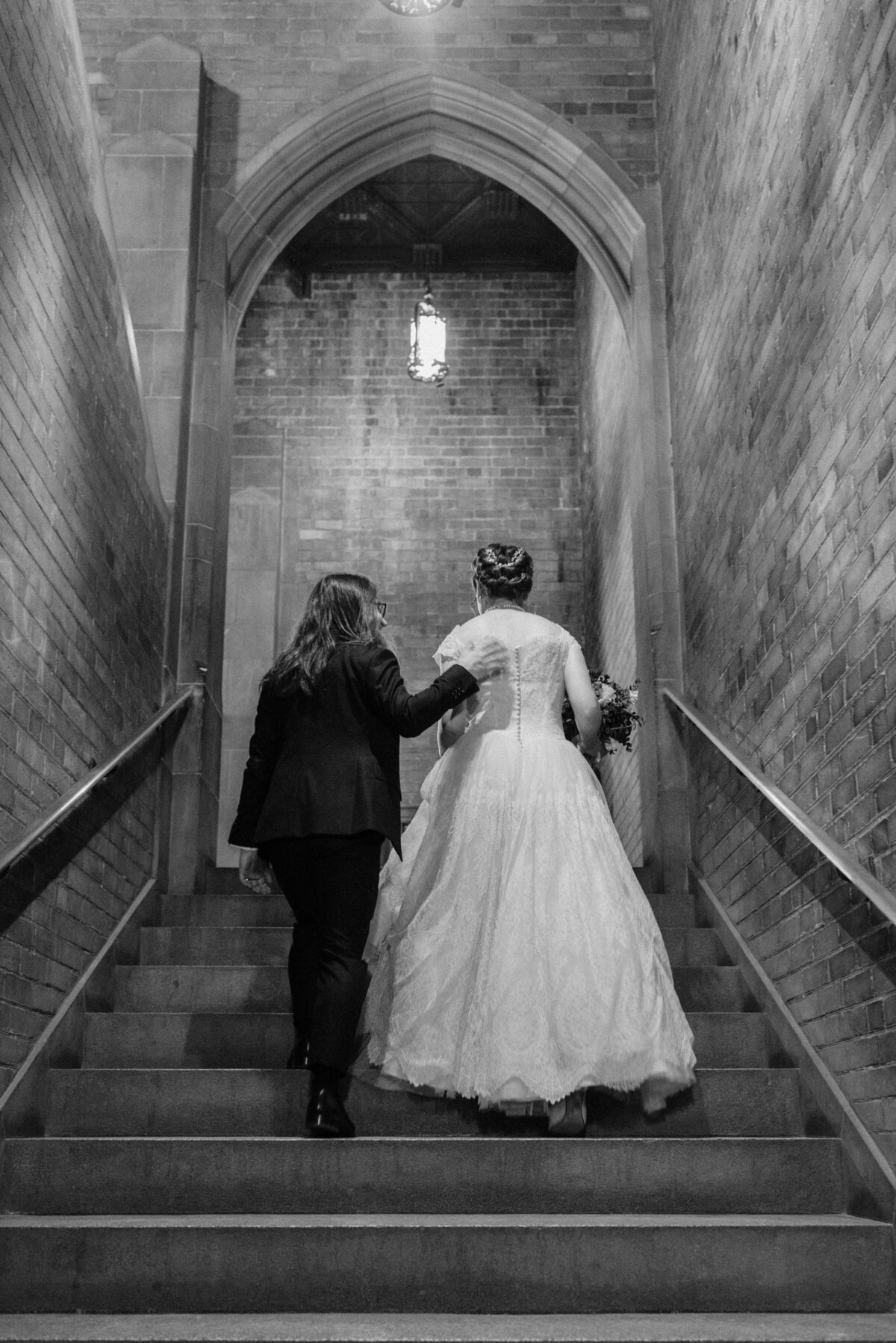 bride and groom walk up the stairs at their hart house wedding