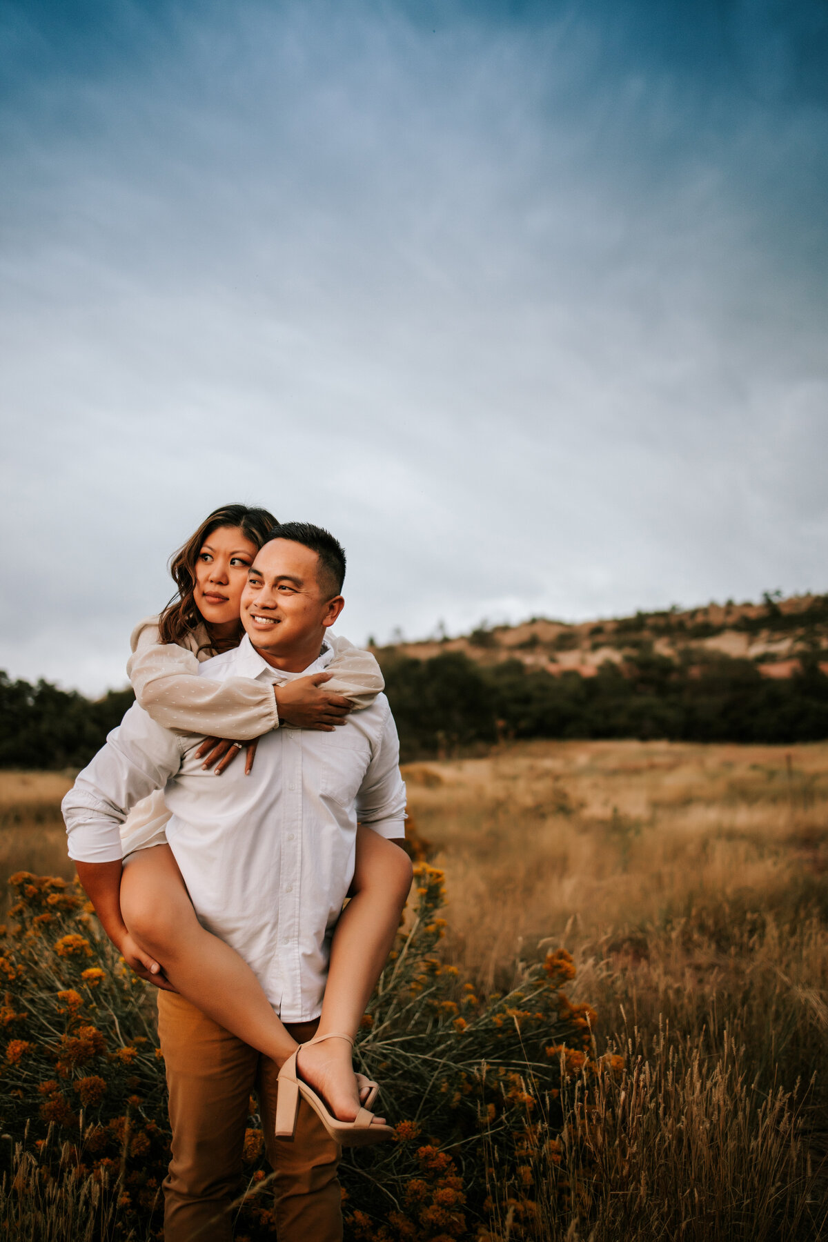 Colorado couple hold eachother in the middle of fall foliage for a couples session