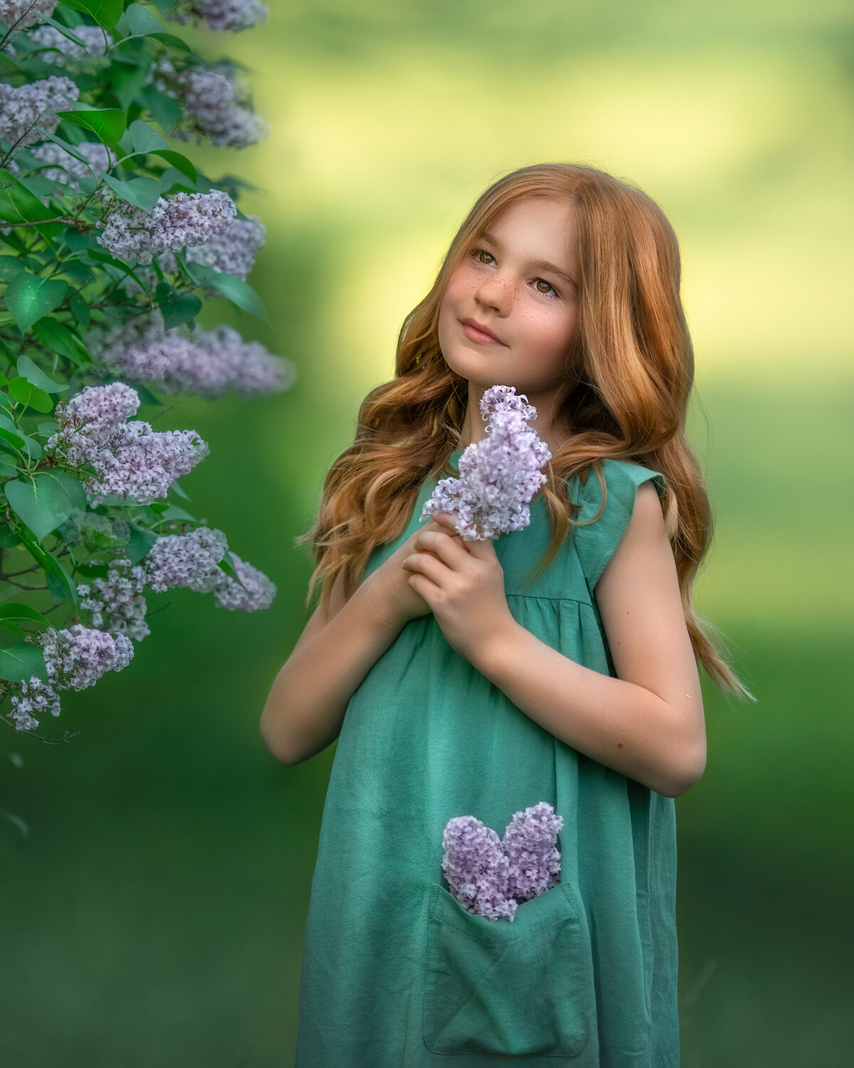 redhead in mint color dress from Target holding purple lilac flowers.