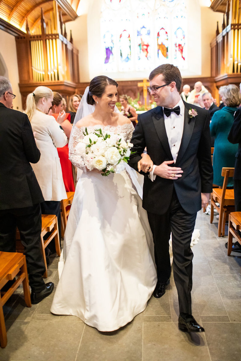 just-married-walking-down-aisle-dahlgren-chapel