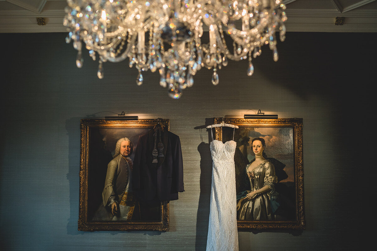 The birds the wedding dress is hanging on to portraits in the bridal suite