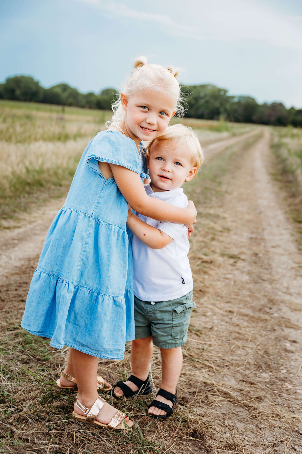 Sister and brother embrace in a hug in Central Nebraska