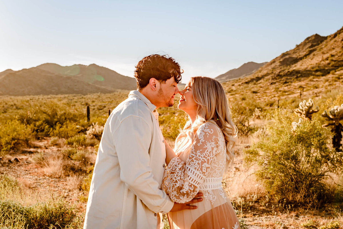 couple kissing during maternity session with AZ photographer