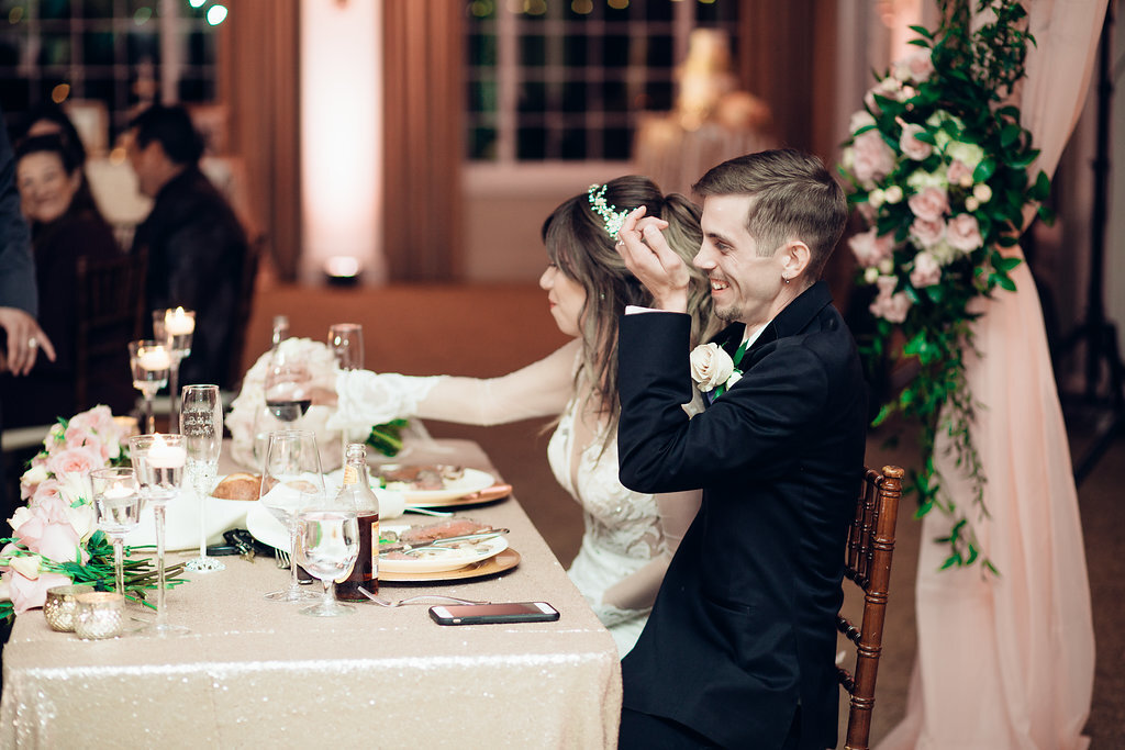 Wedding Photograph Of Bride And Groom Laughing While Seated Los Angeles