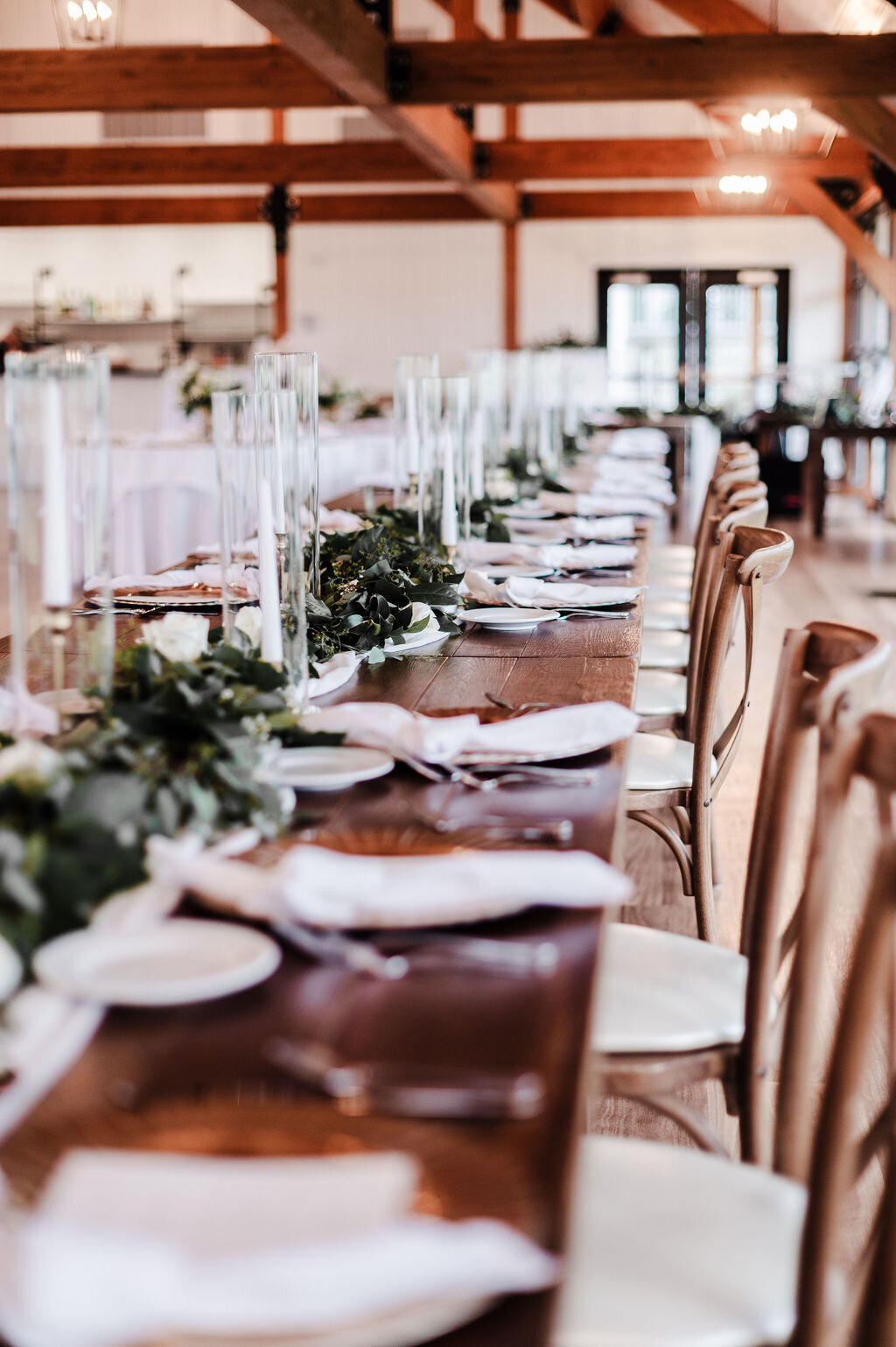 Farm table with garland greenery and gold taper candles
