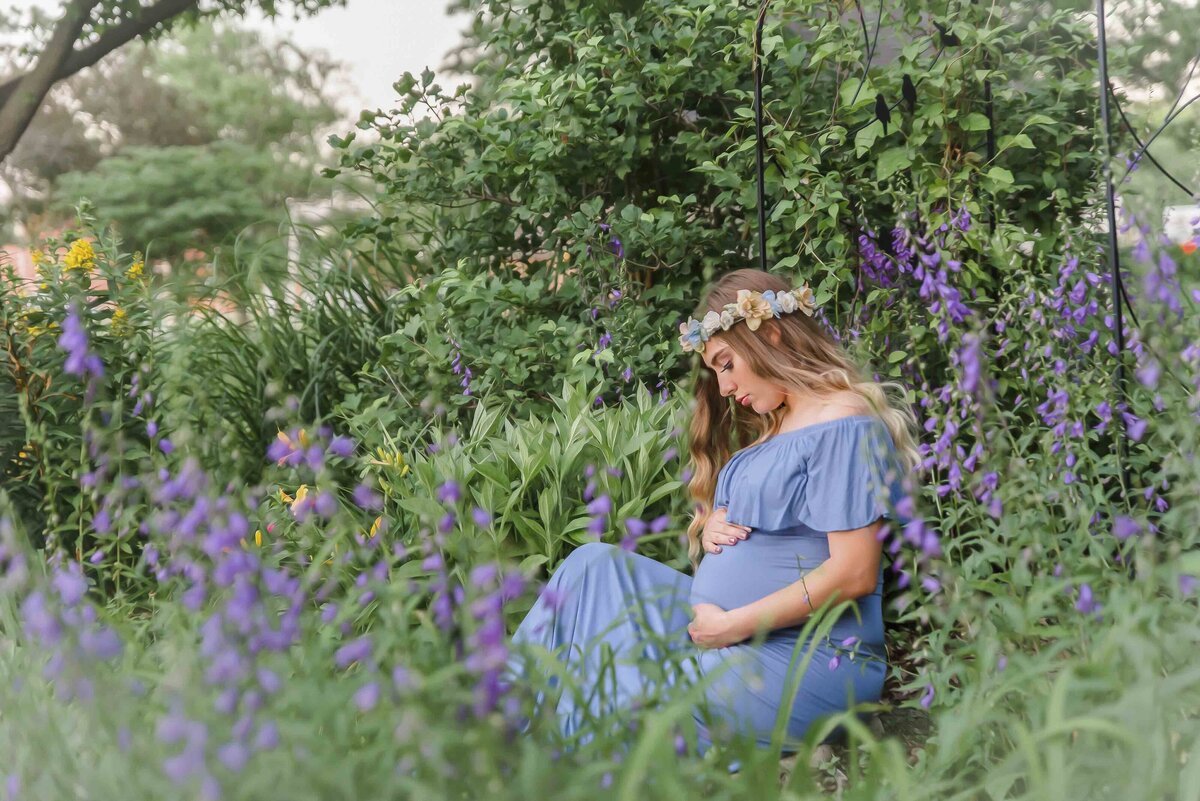 A motherhood maternity photo of a pregnant woman in a garden of flowers in Mexico Missouri