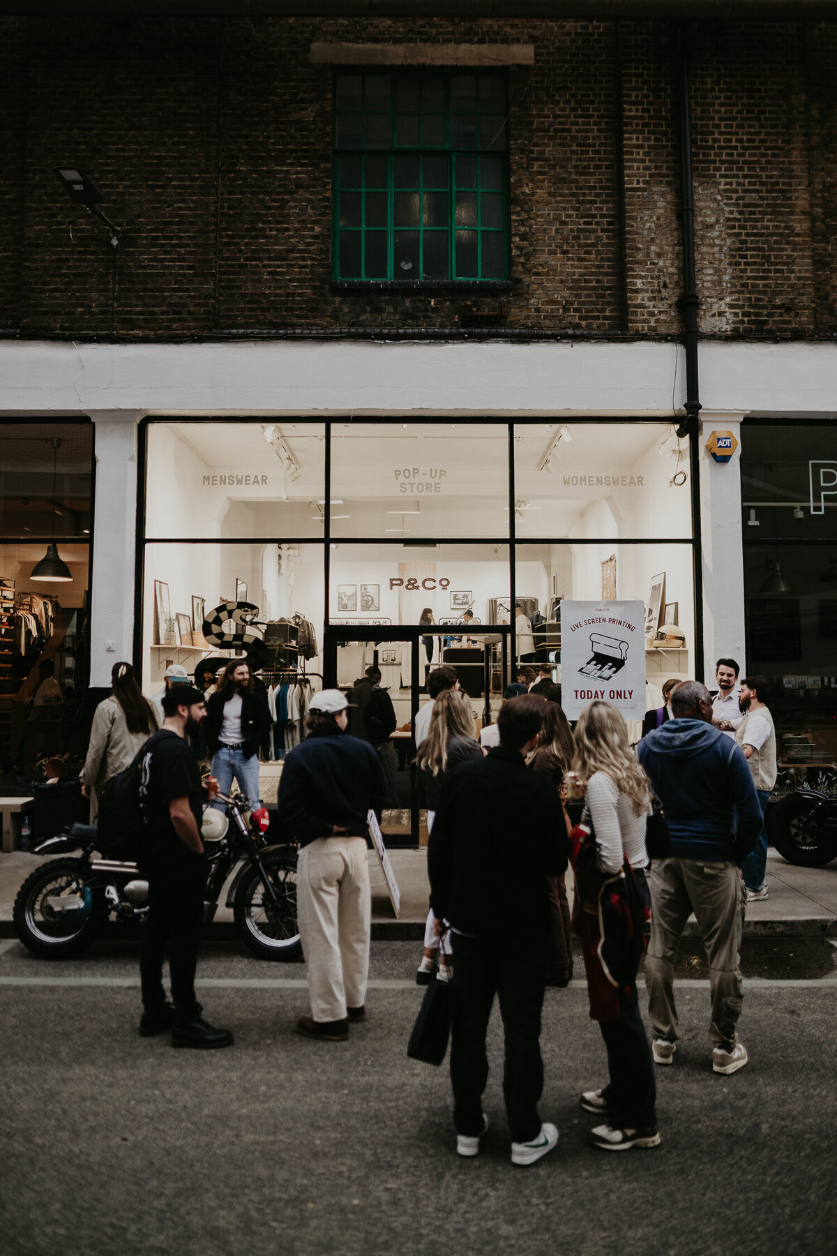 A group of people partying outside the P&co Pop up store in Shoreditch