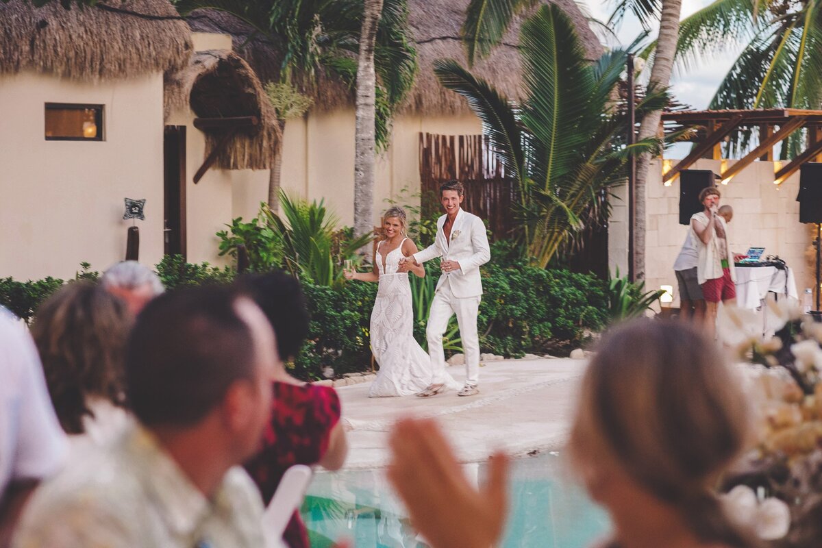 Bride and groom entering reception at viceroy riviera maya wedding