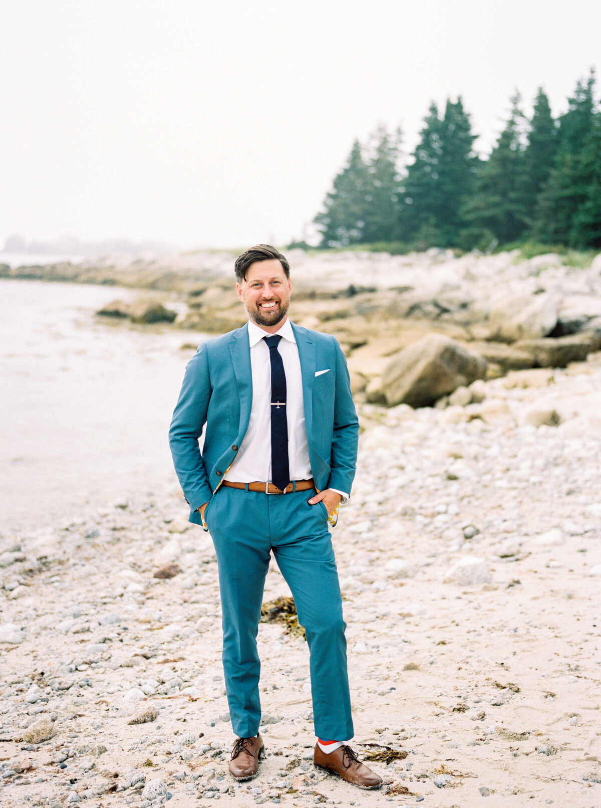 Groom standing on the sand at Oceanstone Resort Wedding in Nova Scotia