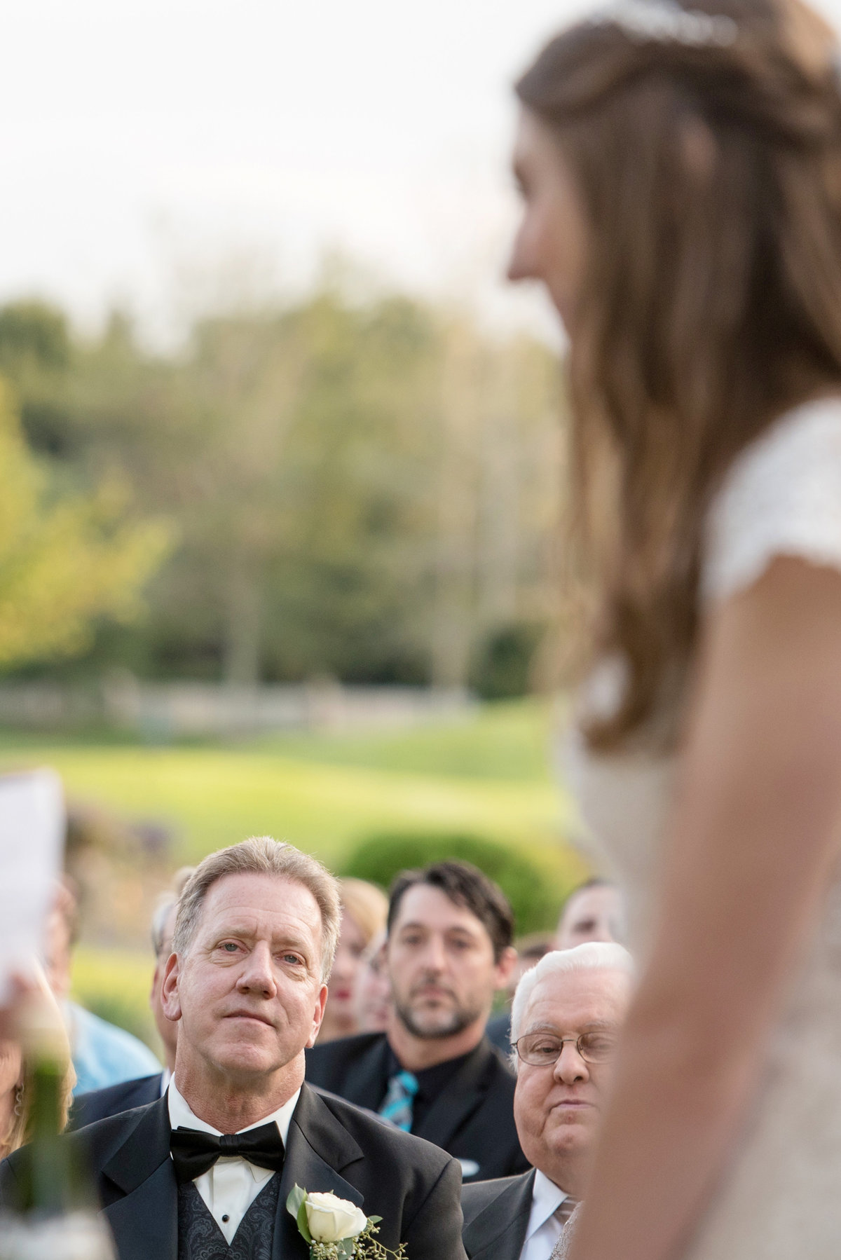 dad looking at bride during ceremony at Willow Creek Golf and Country Club