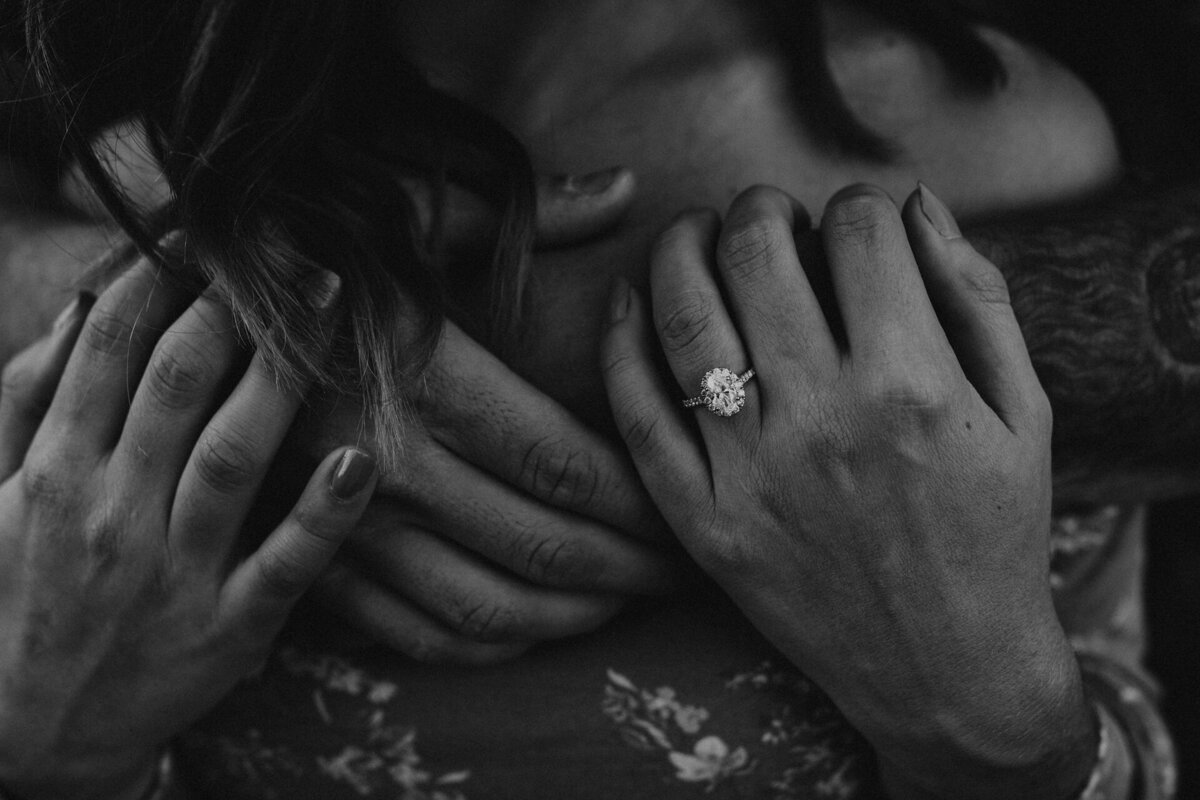 Couple's hands with engagement ring