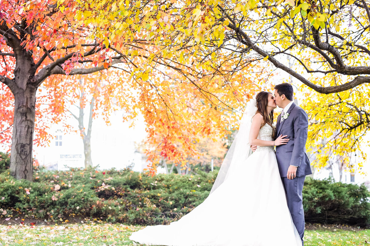 njeri-bishota-lauren-ashley-wedding-bride-groom-outdoors-fall-leaves-trees-colors