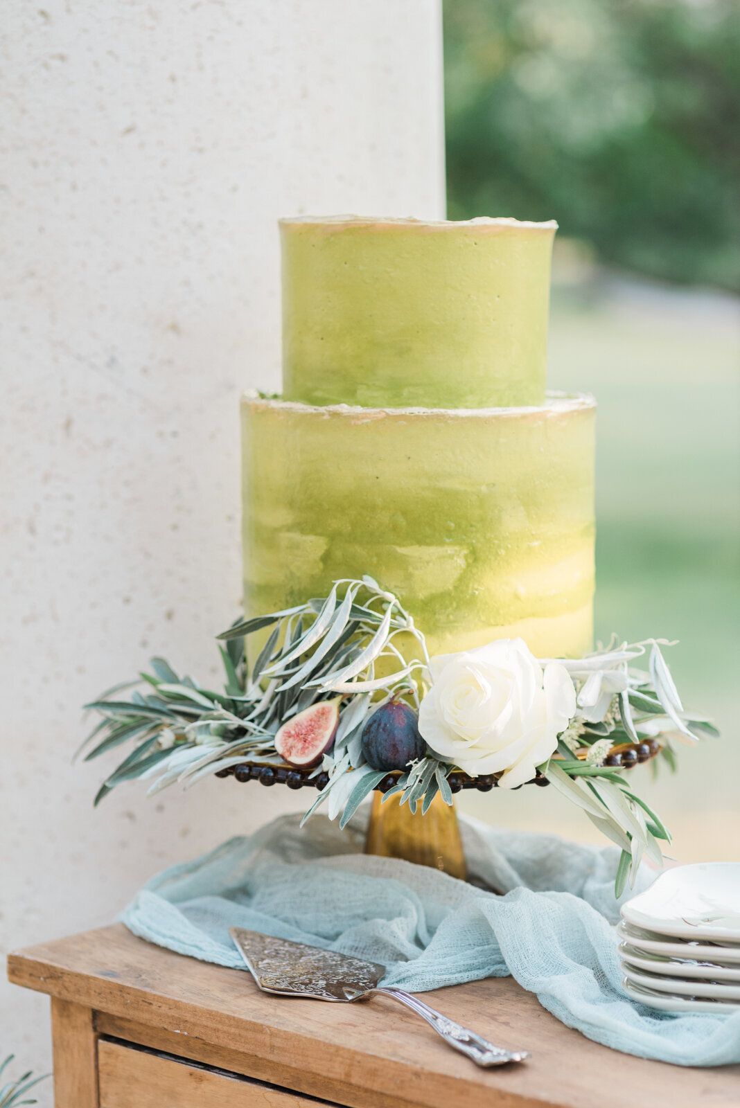 Trendy lime green ombre wedding cake, decorated with white rose, greenery, and fresh pears, by Lemonberry Pastries, contemporary cakes & desserts in Calgary, Alberta, featured on the Brontë Bride Vendor Guide.
