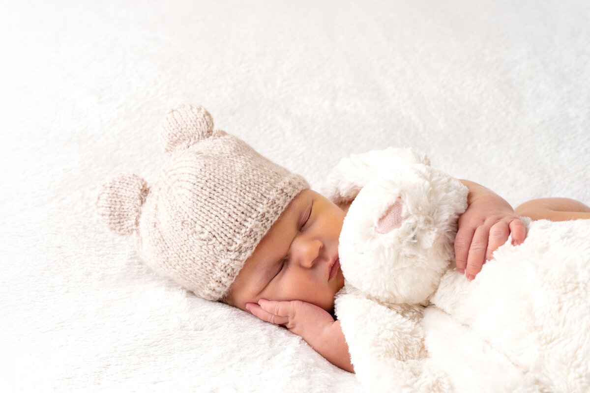 newborn-baby-posing-with-white-teddy
