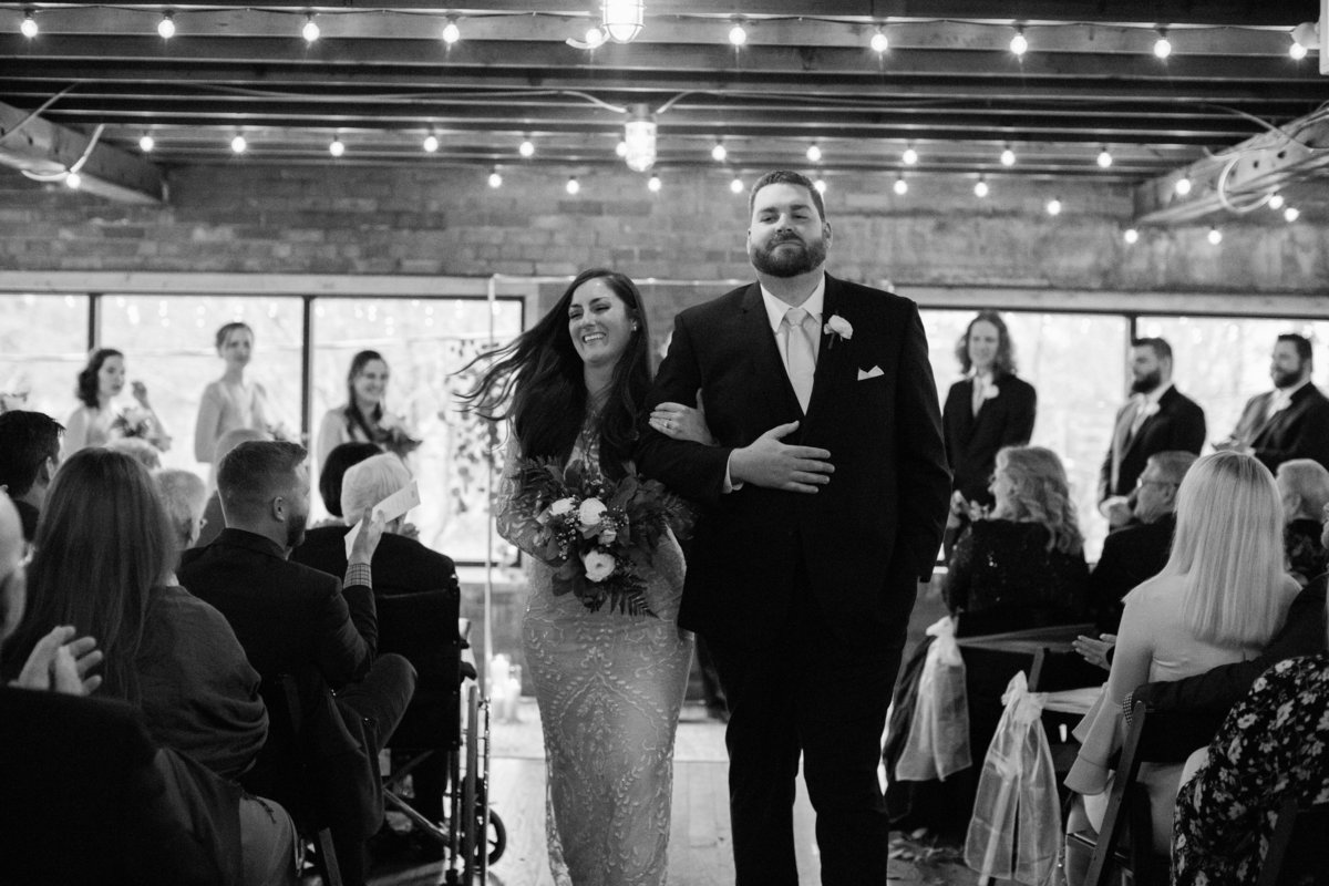 Wedding Photographer, black and white of couple walking down the aisle