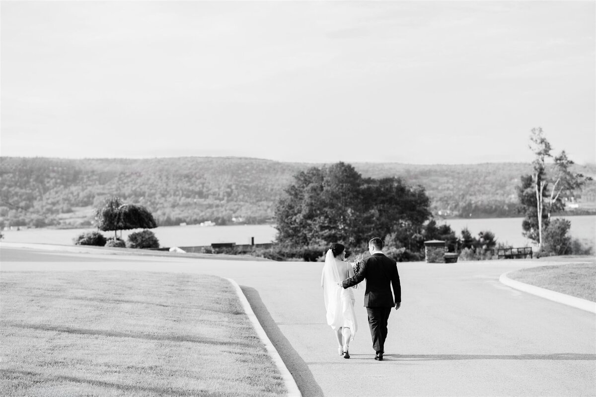 Bride and groom walking on the Lakes Resort Property on their wedding day, Photography taken by CDM Photography, One of Cape Breton Island's Wedding Photogtraphers