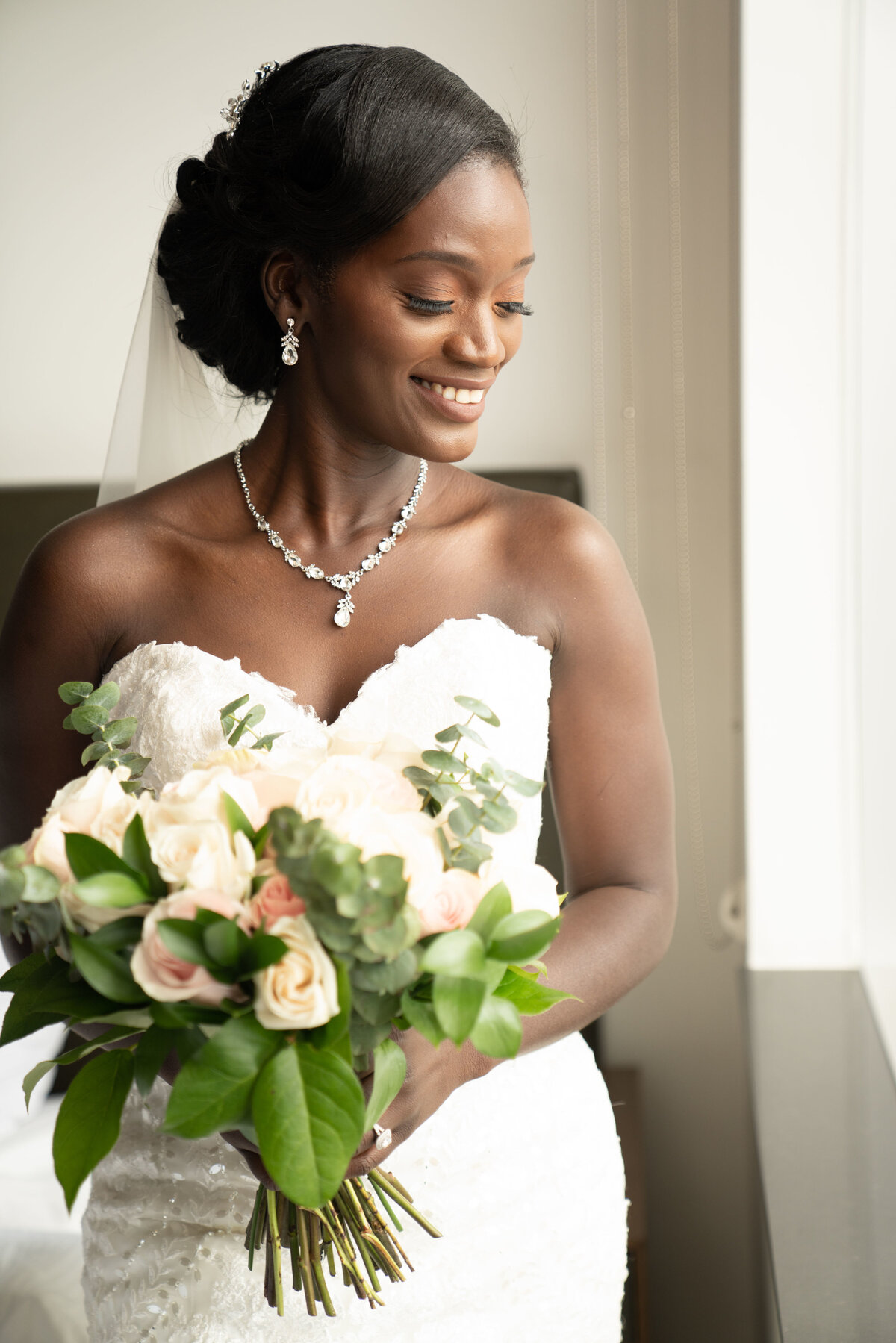 oruka events nigerian wedding planner in toronto black bride in white dress holding green and blush bouquet wiht pin up hair happy classy unique fun outdoor arlington estate  CLP07182