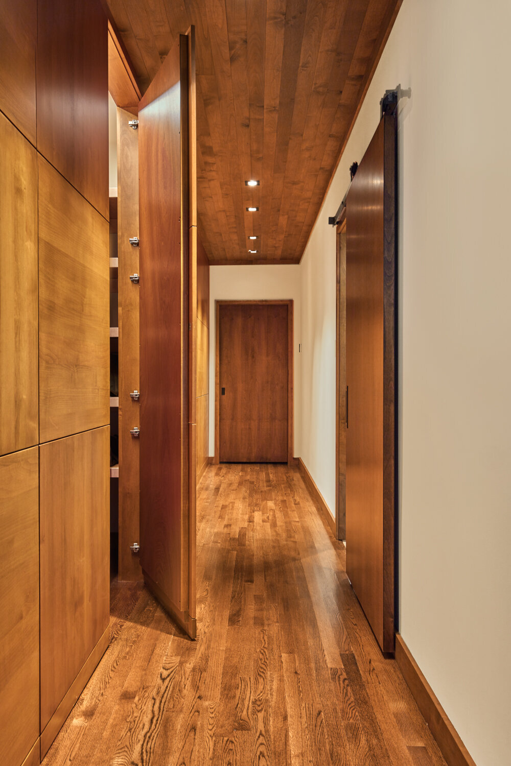 Panageries Residential Interior Design | Pacific NW Modern Dwelling Chocolate Hallway with a hidden door