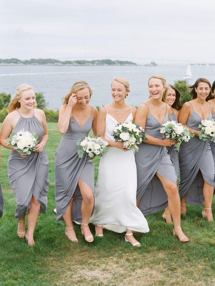 wedding bridal party walking from the ocean at newport castle hill