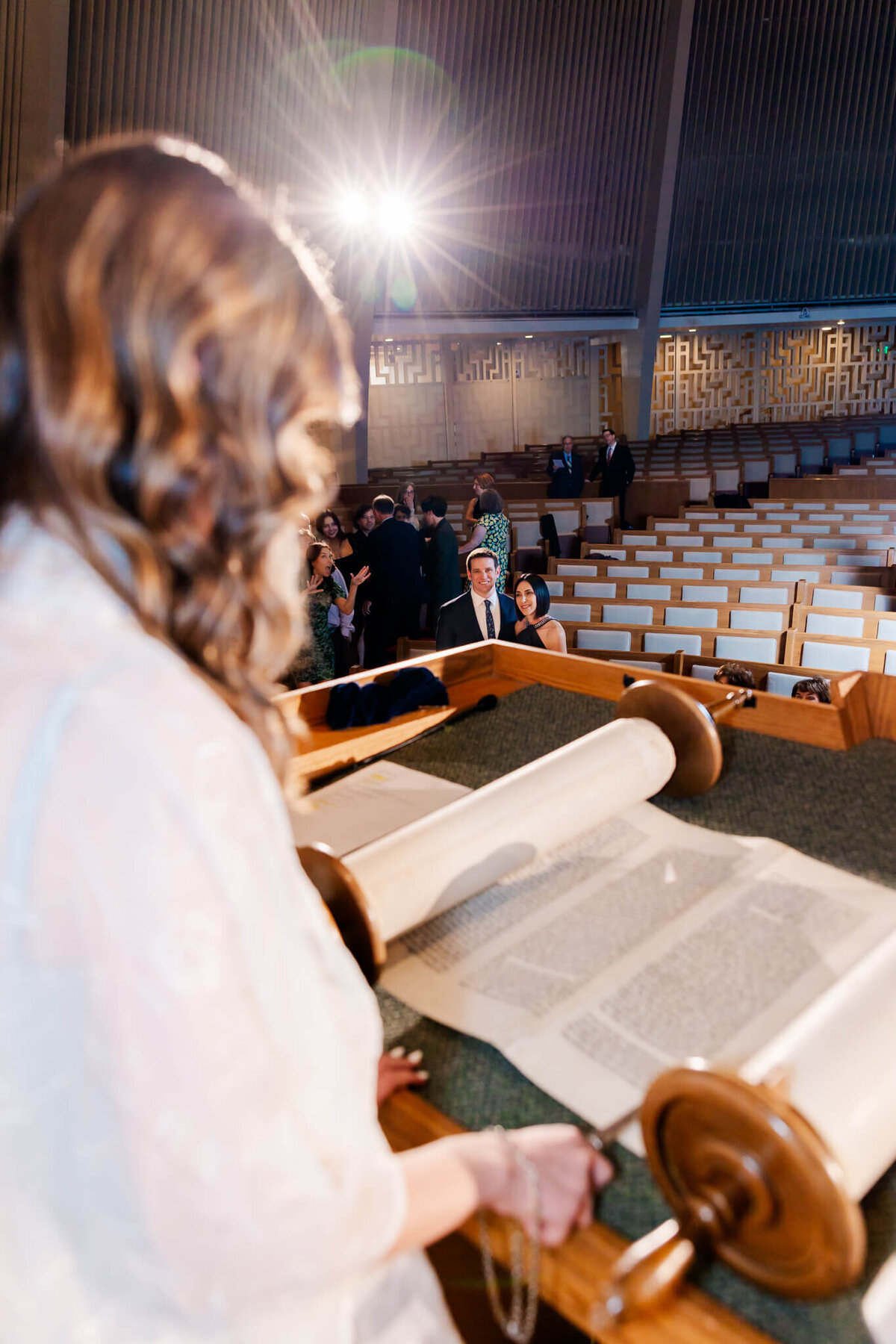 A peek over a teen girl's shoulder as she reads the torah in a temple