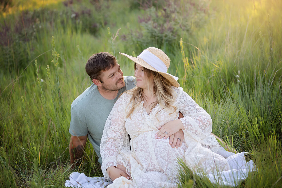An expecting couple poses for their outdoor maternity session in Mankato.