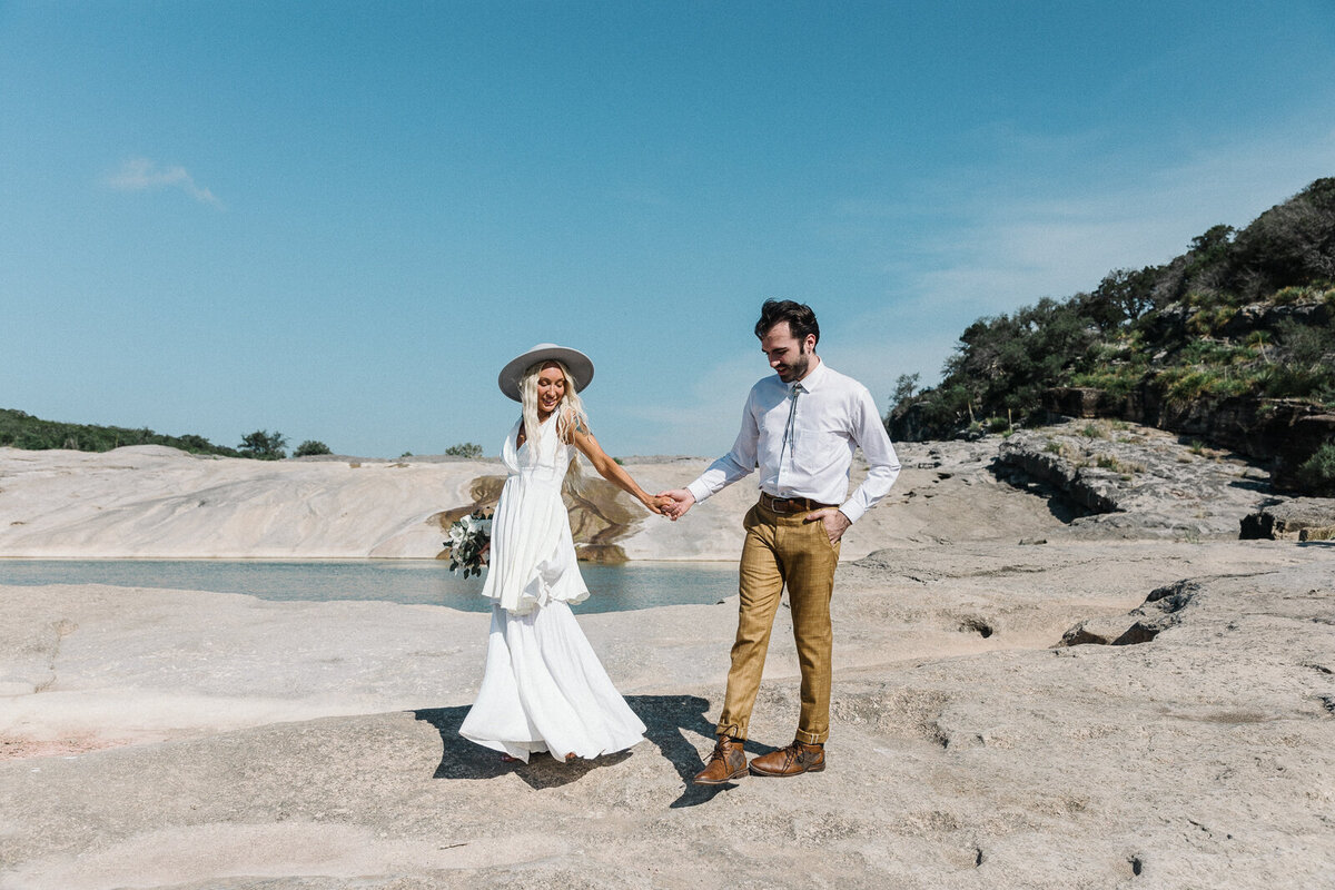 boho bride holding hands with groom for elopement in croatia mountains