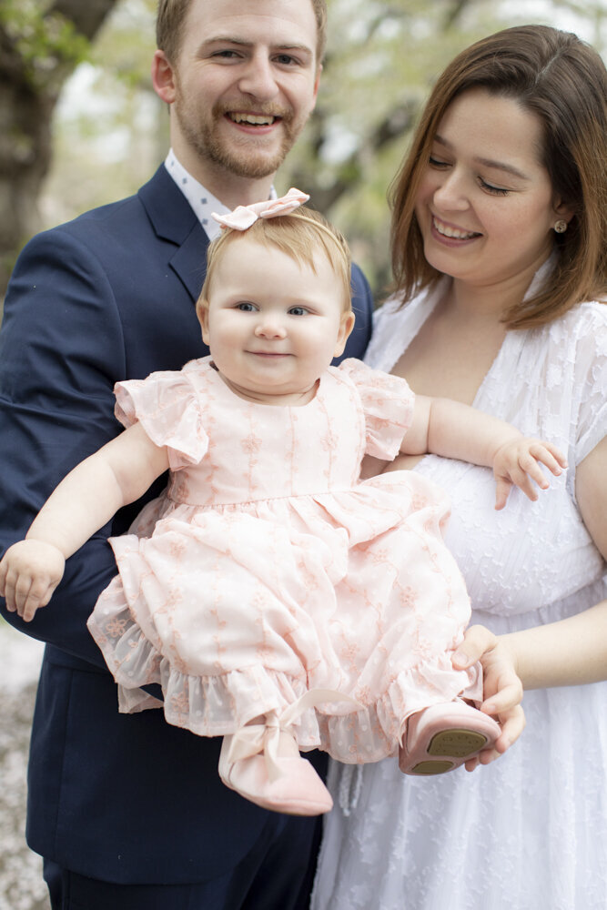portrait of baby girl with her parents