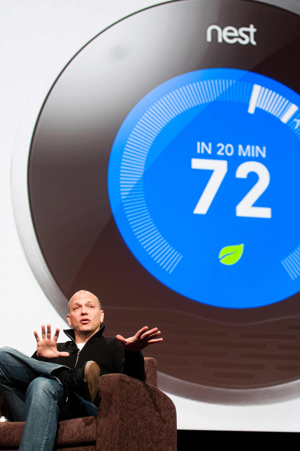 Nest Founder who also designed at Apple speaks with Nest displayed behind him.