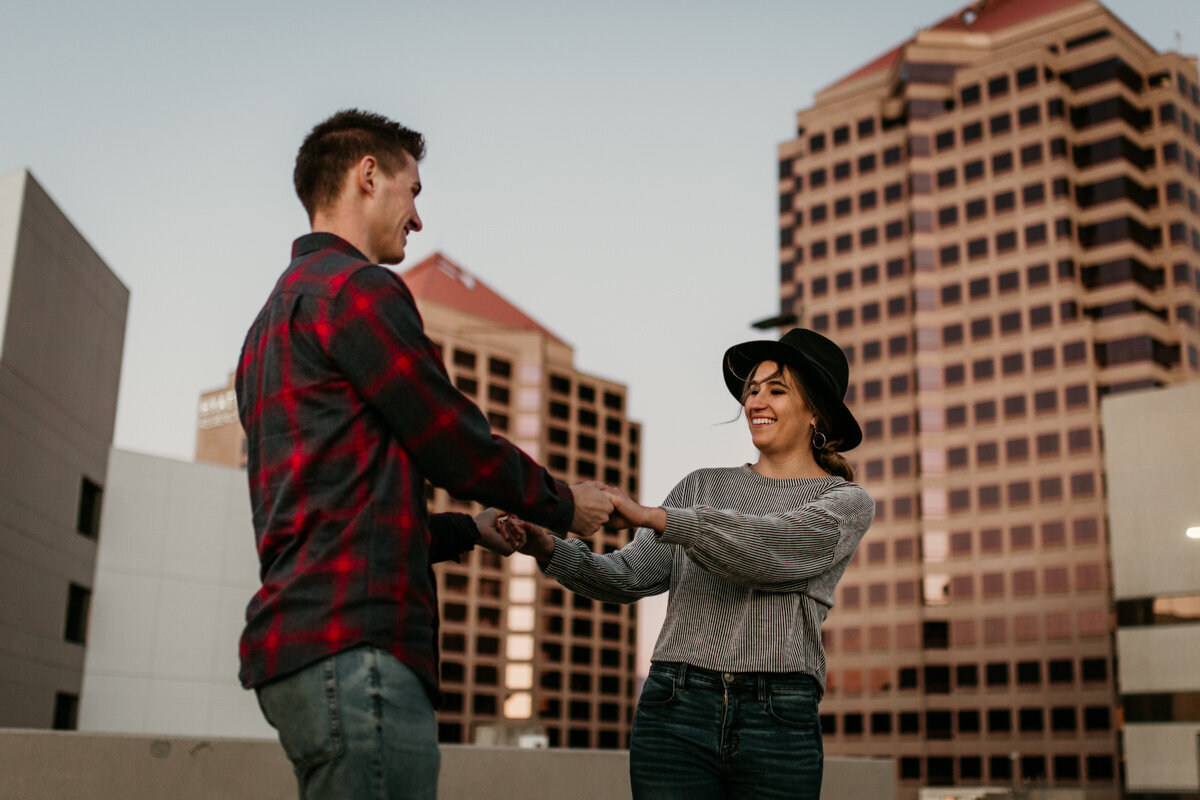 couple spinning on downtown rooftop