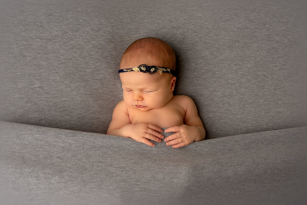 newborn-baby-posing-under-blanket
