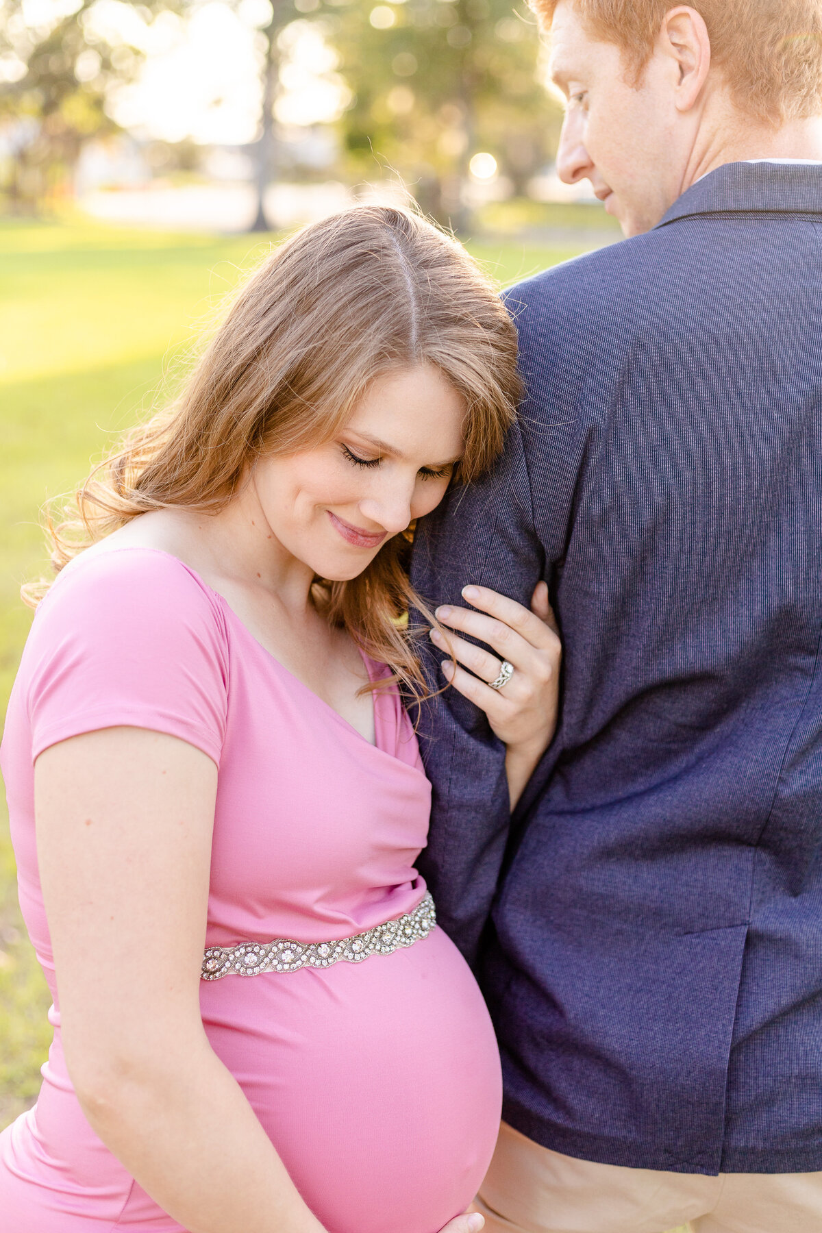 Mom to be posing with her husband during maternity session