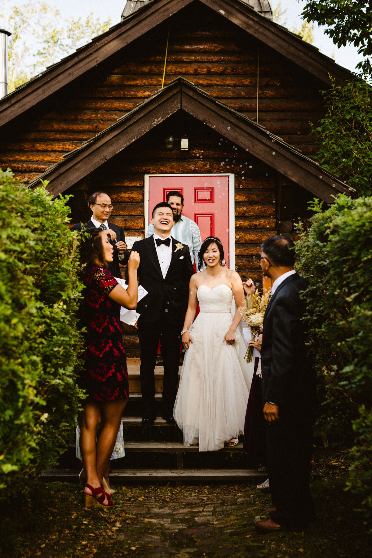 couple celebrates after vows on steps of small church in ninilchik alaska
