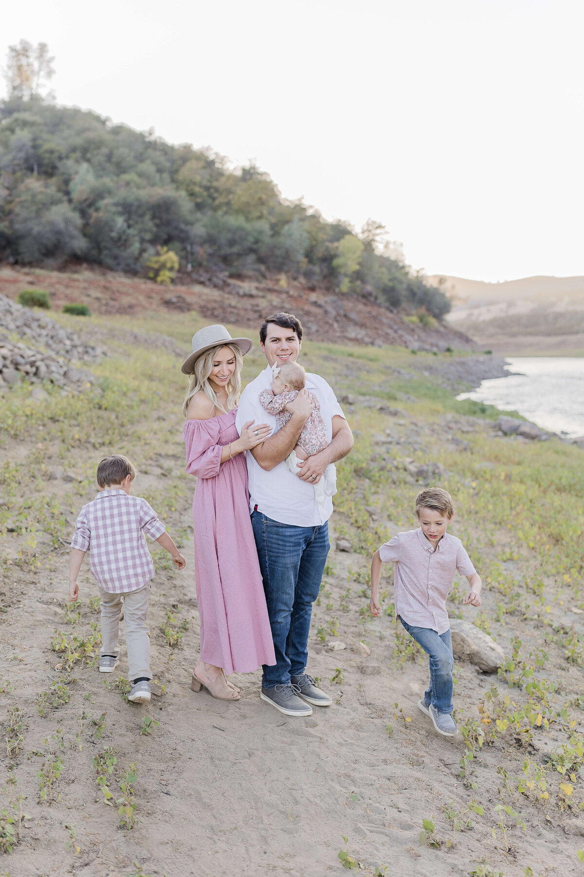A gorgeous family playing by the sacramento river enjoying their family photography by Caroline Bendel