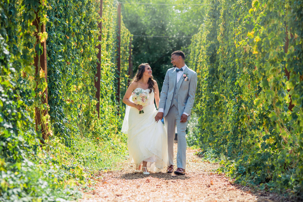 bride and groom walking in hops