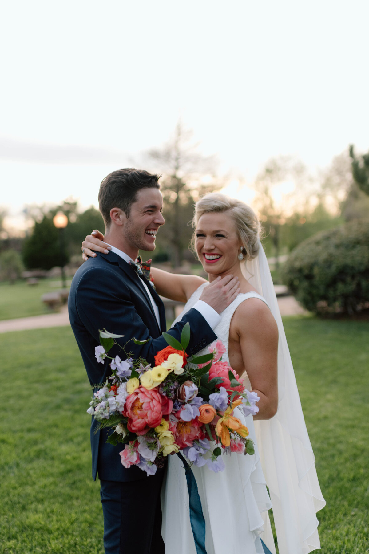 bride and groom smiling during golden hour photos at coles garden