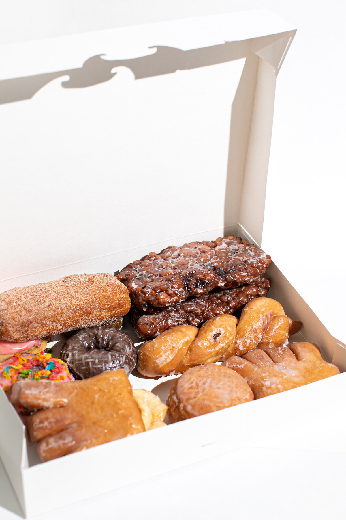 Assorted Donuts Piled up in a white box - Daylight Donuts