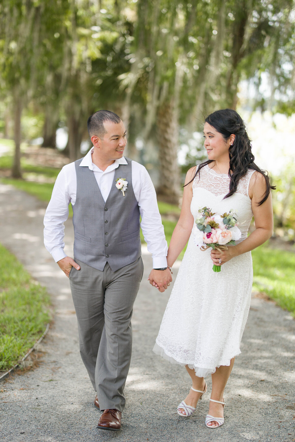 bride and groom walking byby Lucas Mason Photography in Orlando, Windermere, Winder Garden area
