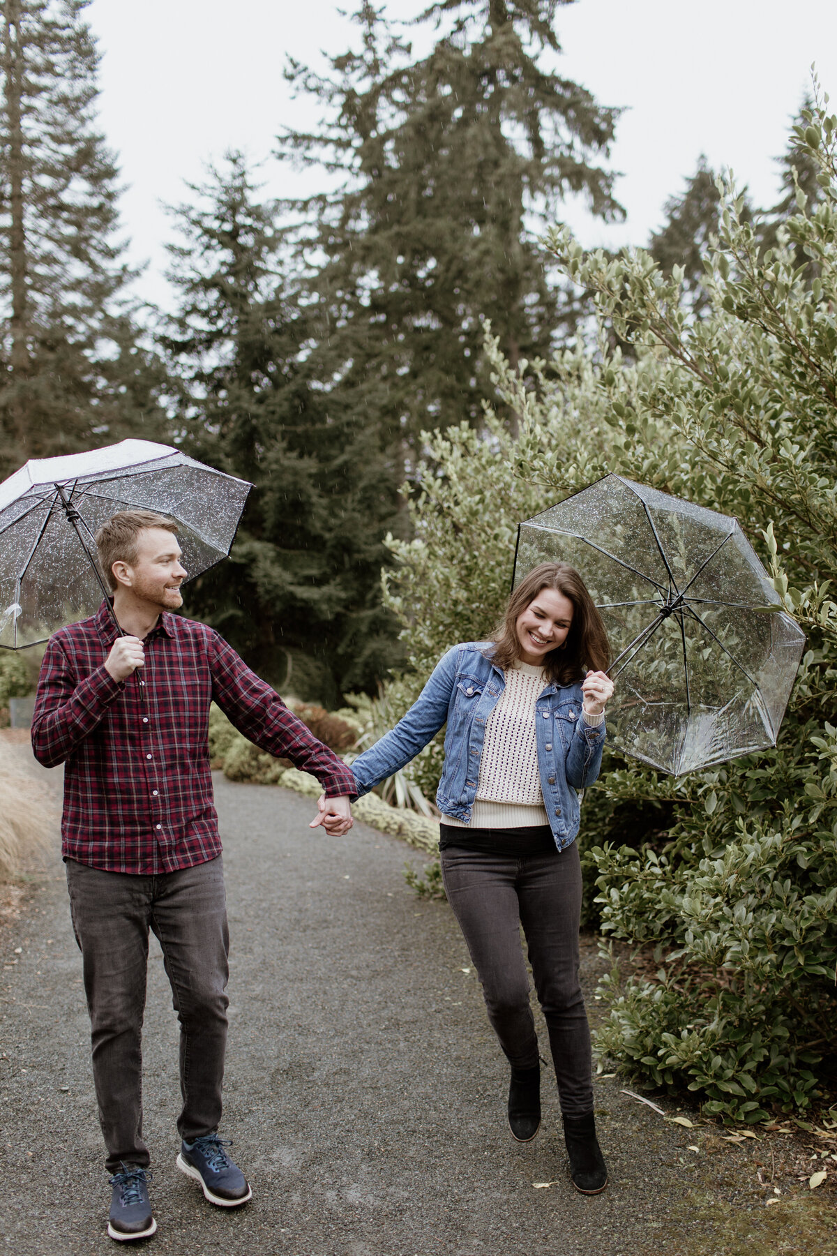 A candid and playful engagement session in the rain captured by Fort Worth Wedding Photographer, Megan Christine Studio