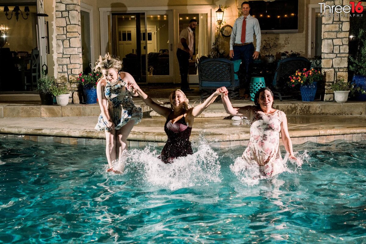 Three ladies jump in the pool after Minimony Celebration at the Newhall Mansion in Piru, CA