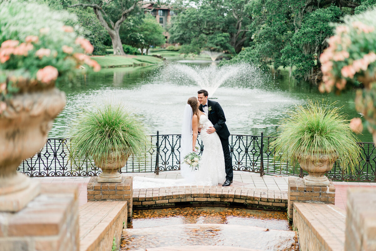 Bride and groom with fountain in background in Alabama