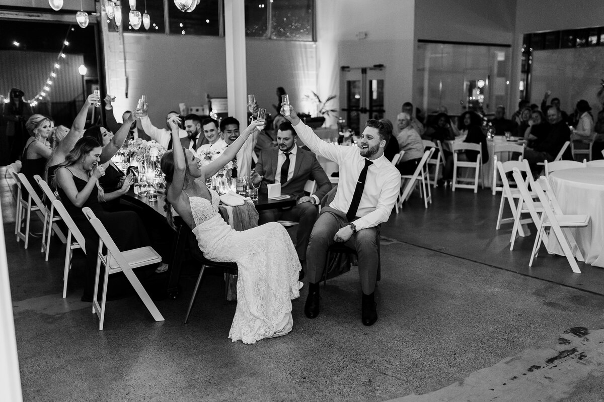 Bride and groom sitting at table and cheersing