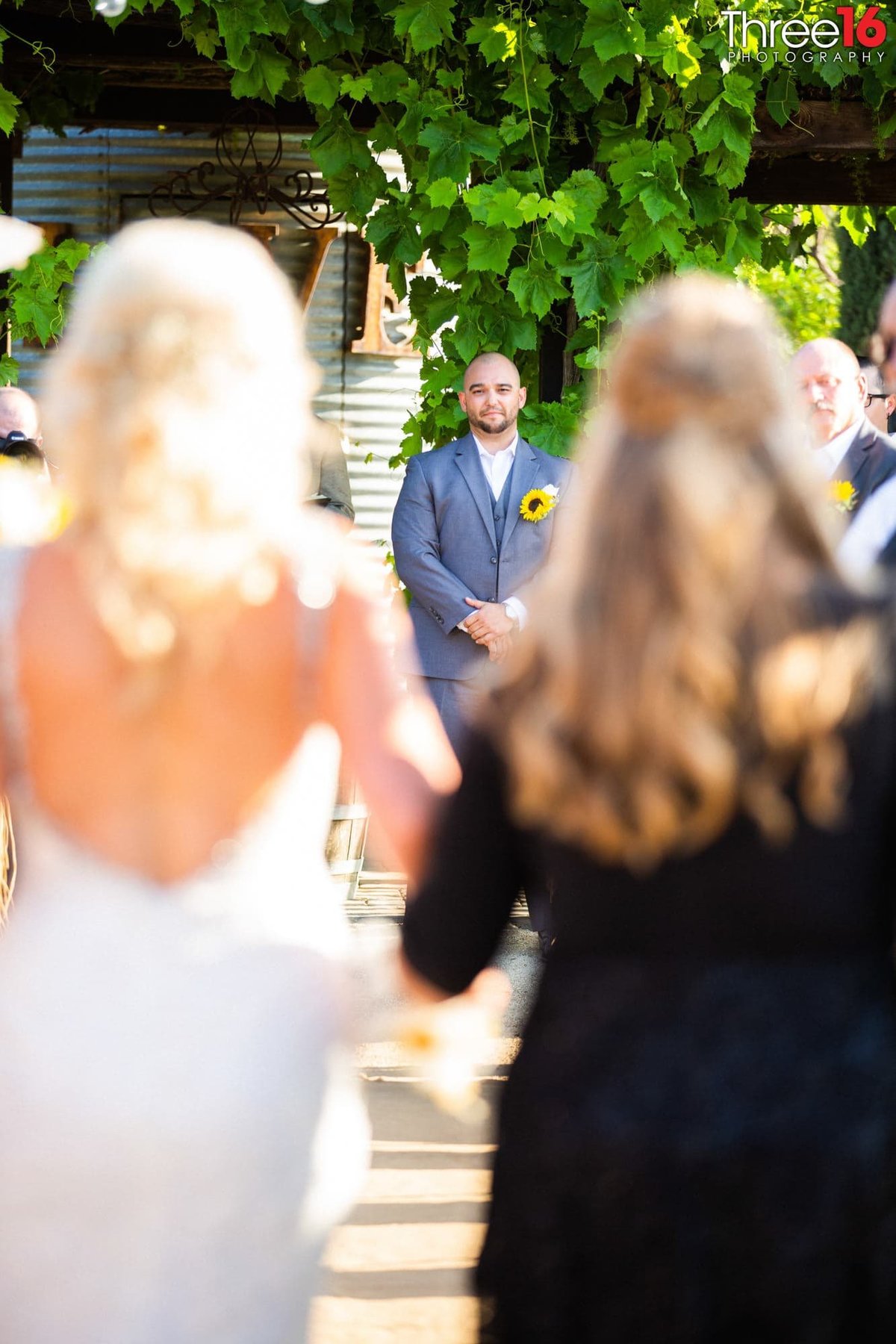 Groom standing at the altar as Bride enters