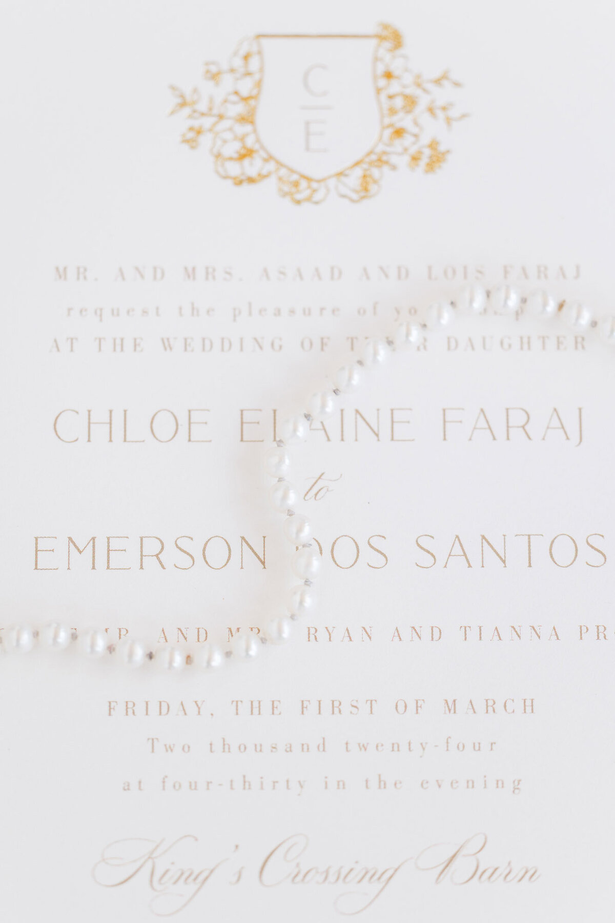 close up of bridal jewelry on wedding invitation