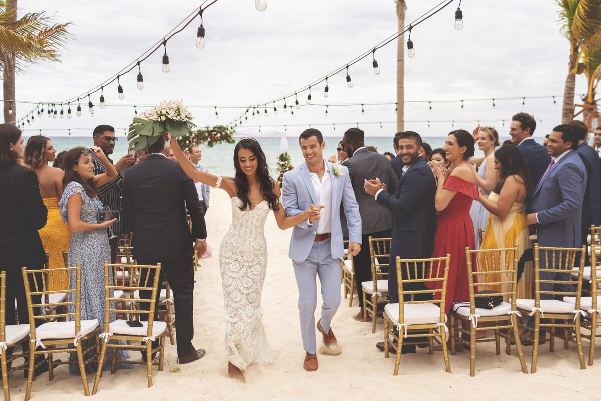 Bride and groom celebrate after wedding ceremony in Riviera Maya