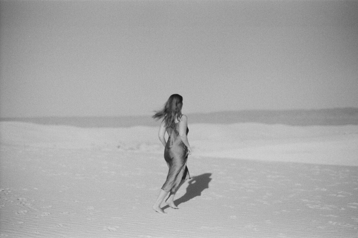 woman running in white sands new mexico