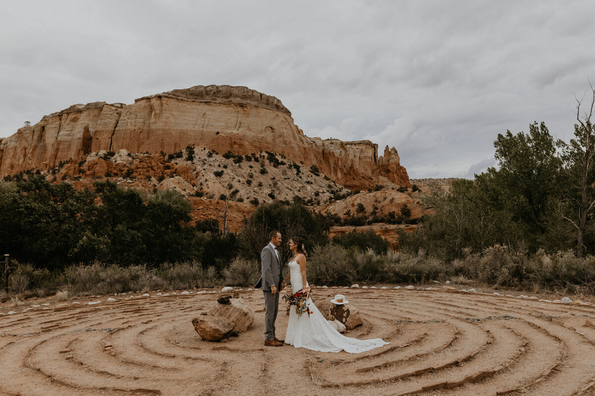 bride and groom standing in the labyrinth at Ghost Ranch